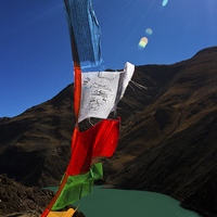 Buy canvas prints of The Yamdrok Lake of Tibet with prayer flags by Julian Bound