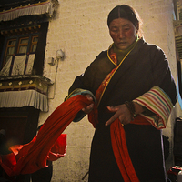 Buy canvas prints of Jokhang Temple Tibetan Lady, Lhasa, Tibet  by Julian Bound