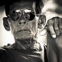 Buy canvas prints of Man in sunglasses in Yogyakarta, Indonesia by Julian Bound
