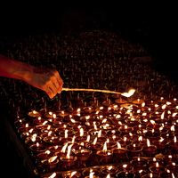 Buy canvas prints of  Candle blessings, Kathmandu, Nepal by Julian Bound