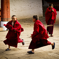 Buy canvas prints of  Monks at play in Rinpung Dzong Fort, Bhutan by Julian Bound