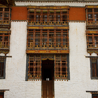 Buy canvas prints of Two monks of Tashi Chho Dzong Fortress, Bhutan by Julian Bound