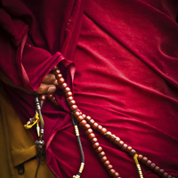 Buy canvas prints of Tibetan monk and beads, Boudhanath Temple, Kathman by Julian Bound