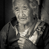 Buy canvas prints of Elderly Tibetan lady, Boudhanath Temple, Kathmandu by Julian Bound