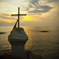 Buy canvas prints of Sunset and crucifix, Vagator, Goa, India by Julian Bound