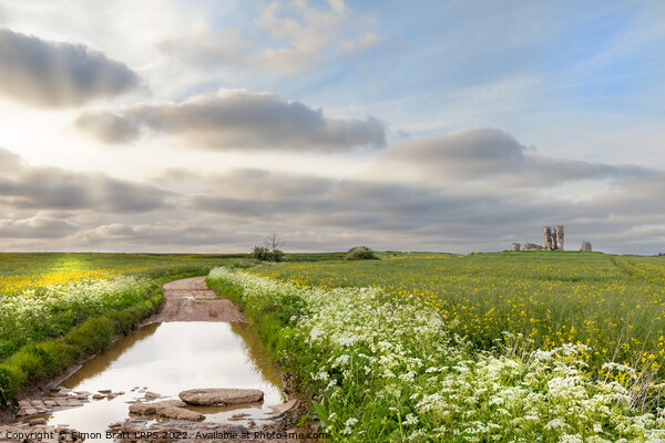Flooded broken road leading to ruined Bawsey church Picture Board by Simon Bratt LRPS