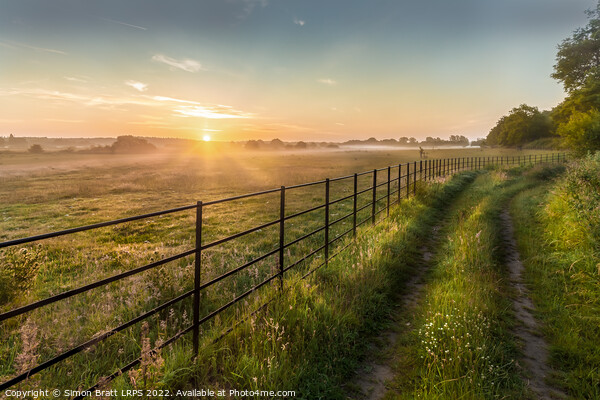 Castle Rising Norfolk sunrise over rural fields fe Picture Board by Simon Bratt LRPS