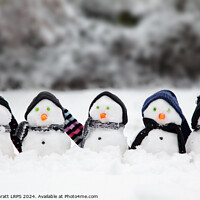Buy canvas prints of Cute little snowmen dressed in hats and scarfs in snow by Simon Bratt LRPS