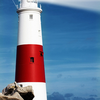 Buy canvas prints of Portland Bill Lighthouse on rocks by Simon Bratt LRPS