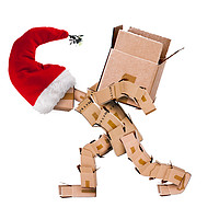 Buy canvas prints of Christmas character carrying a large box  by Simon Bratt LRPS