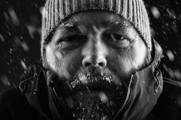 Man freezing in snow storm close up Picture Board by Simon Bratt LRPS