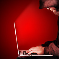 Buy canvas prints of Hooded computer hacker red background by Simon Bratt LRPS