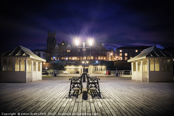 Cromer pier Norfolk at night looking towards town Picture Board by Simon Bratt LRPS