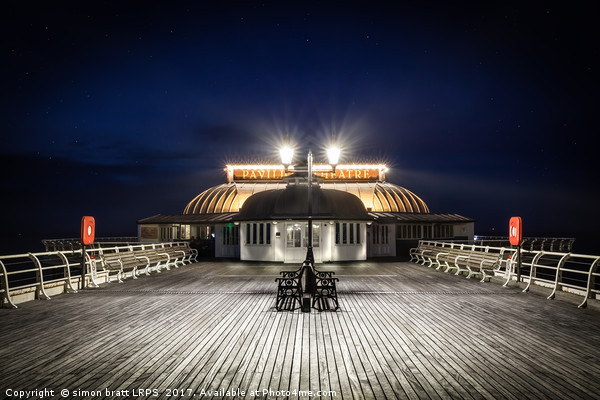 Cromer pier pavilion at night in Norfolk Picture Board by Simon Bratt LRPS