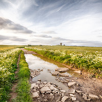 Buy canvas prints of Flooded road landscape leading to ancient ruin by Simon Bratt LRPS