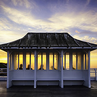 Buy canvas prints of Cromer pier people watching sunset in Norfolk UK by Simon Bratt LRPS