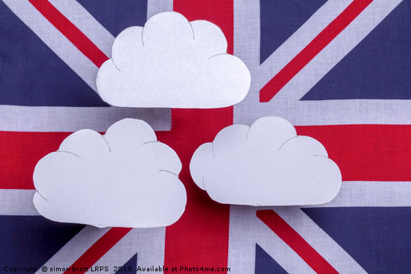 British flag with three white clouds floating abov Picture Board by Simon Bratt LRPS