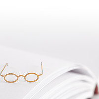 Buy canvas prints of Tiny reading glasses on open book by Simon Bratt LRPS