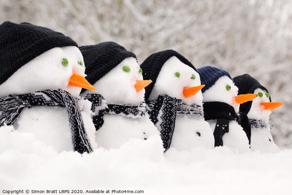 Snowmen close up in a row Picture Board by Simon Bratt LRPS
