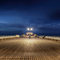 Buy canvas prints of Cromer Pier Norfolk under a moon lit sky by Simon Bratt LRPS