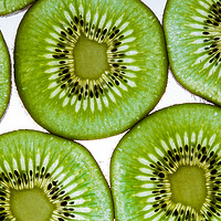 Buy canvas prints of Green  kiwi fruit slices by Chris Warham