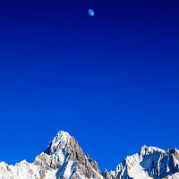Buy canvas prints of Moon above the French Alps against a deep blue sky by Chris Warham
