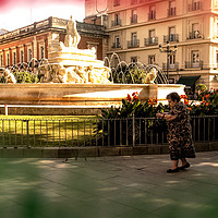 Buy canvas prints of An old lady is walking in front of a fountain by Jose Manuel Espigares Garc