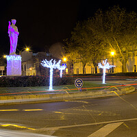 Buy canvas prints of Lights in the evening near a sculpture by Jose Manuel Espigares Garc