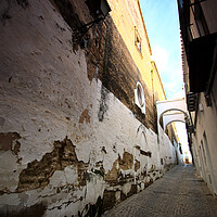 Buy canvas prints of Narrow and lonely street with arch by Jose Manuel Espigares Garc