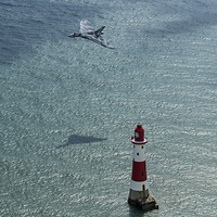 Buy canvas prints of  Avro Vulcan low pass over Eastbourne lighthouse by Mike Sannwald