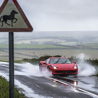 Buy canvas prints of  Ferrari 458 Spider driving through a puddle by Mike Sannwald