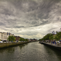 Buy canvas prints of View to the Ha'penny Bridge Dublin on a stormy day by DEREK ROBERTS
