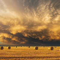Buy canvas prints of Mammatus clouds & Hay-bails at sunset by John Finney