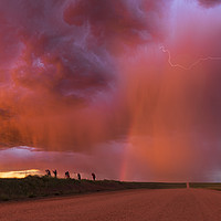 Buy canvas prints of Sunset thunderstorm with rainbow and lightning. by John Finney