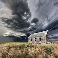Buy canvas prints of Abandoned Schoolhouse with a Storm, Colorado by John Finney