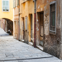 Buy canvas prints of Old houses on narrow street in Villefranche-sur-Me by ELENA ELISSEEVA