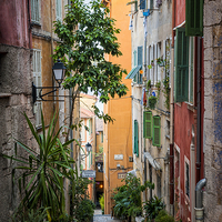 Buy canvas prints of Colorful old street in Villefranche-sur-Mer by ELENA ELISSEEVA
