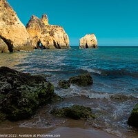 Buy canvas prints of Rocks and Three Brothers Beach in Algarve by Angelo DeVal