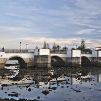 Buy canvas prints of Antique bridge of Tavira and reflections by Angelo DeVal