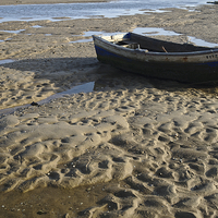 Buy canvas prints of Fishing boat resting on the beach sand  by Angelo DeVal