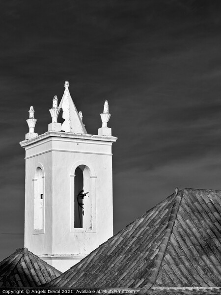 Church bell tower behind tiled roofs in Tavira Picture Board by Angelo DeVal