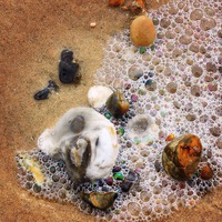 Buy canvas prints of  Pebbles and sea foam bubbles by Emma Healy