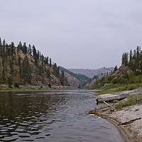 Buy canvas prints of Canoe ashore a river beach along the Snake River  by Wilhelmina Hayward