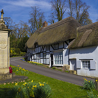Buy canvas prints of Thatched Cottage and War Memorial Wherwell,Hampshi by Philip Enticknap