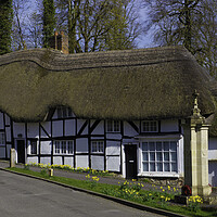 Buy canvas prints of Thatched Cottage and War Memorial Wherwell,Hampshire ,England. by Philip Enticknap