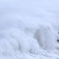 Buy canvas prints of  Porthcawl lighthouse in Storm Abigail. by Andrew Bartlett