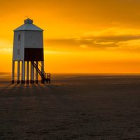 Buy canvas prints of Majestic Wooden Lighthouse at Sunset by Paul Chambers