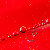 Buy canvas prints of Oil on Water Red and Silver Bubble Abstract by John Williams