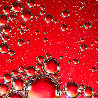 Buy canvas prints of Oil on Water Red and Silver Bubble Abstract by John Williams