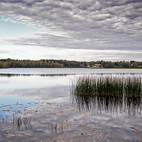 Buy canvas prints of Reflections of the Autumn Lake by Jukka Heinovirta